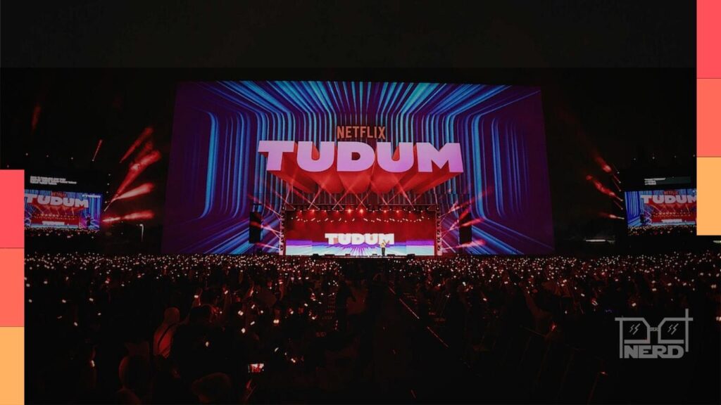 Palco do Tudum 2025 com luzes e telões exibindo produções da Netflix