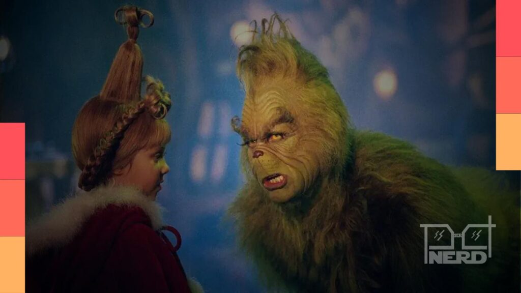 Ilustração do Grinch verde com aparência de Jim Carrey ao lado do diretor Ron Howard, sugerindo O Grinch 2 em desenvolvimento